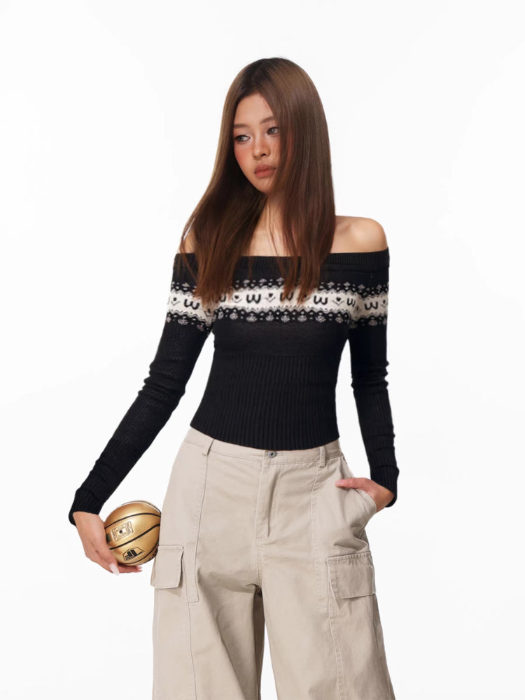 Woman wearing a black off-the-shoulder long-sleeve sweater with a white and black patterned yoke, paired with beige cargo pants.
