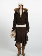 Model wearing a brown textured bomber jacket with a faux fur trimmed hood and white turtleneck