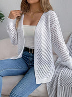 Woman wearing a white open-front pointelle knit cardigan
