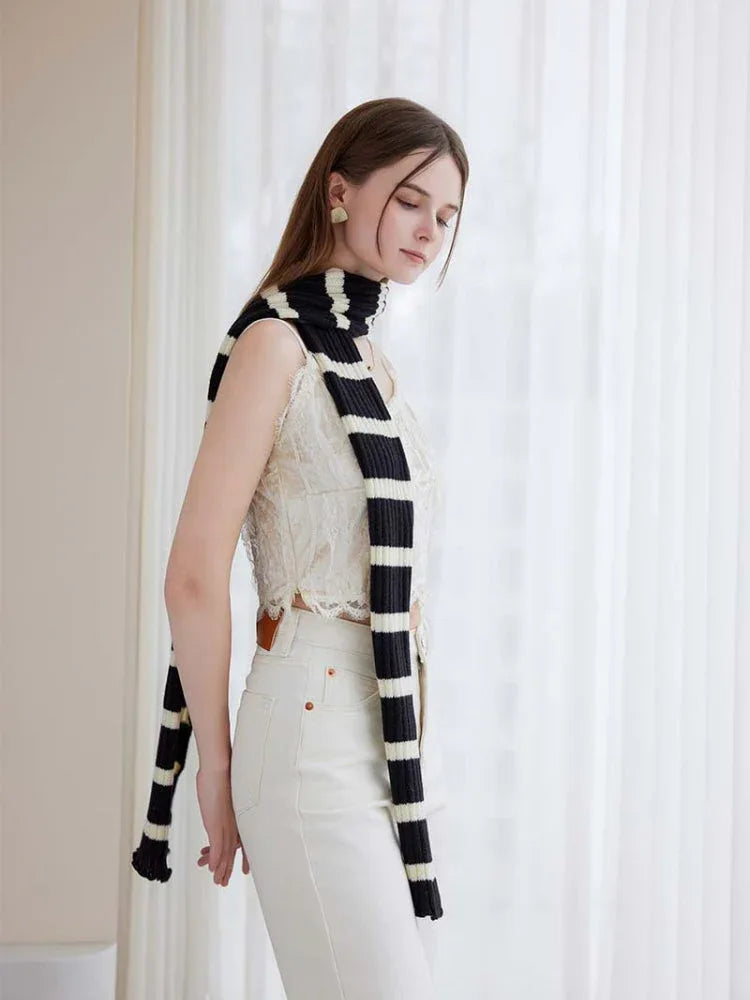 Elegant striped knit scarf draped around the neck