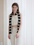 Woman wearing a long black and white striped knit scarf with ruffle edges - View 6 | WEUXS