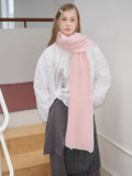 Full-body view of a model in a pink scarf and white puffer jacket