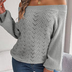 Woman wearing a light gray off-the-shoulder knit sweater with a delicate open-knit pattern and flowing bishop sleeves.