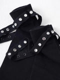 Detail view of the top cuff of black knee-high socks, showing knit texture, stud embellishments, and a strap with hexagonal studs.