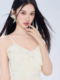 Close-up of the woman's face and the V-neckline of the cream-colored mini dress.
