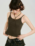 Close-up of the dark olive green halter neck crop top with a cut-out detail and metal ring accent.