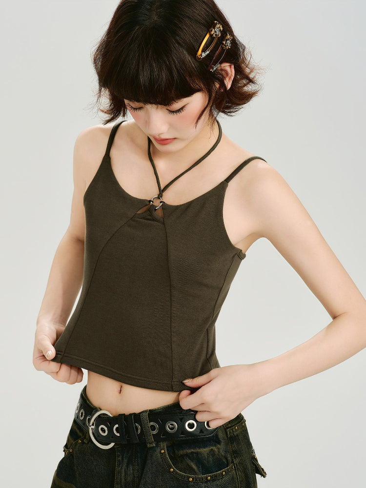 Close-up of the dark olive green halter neck crop top with a cut-out detail and metal ring accent.