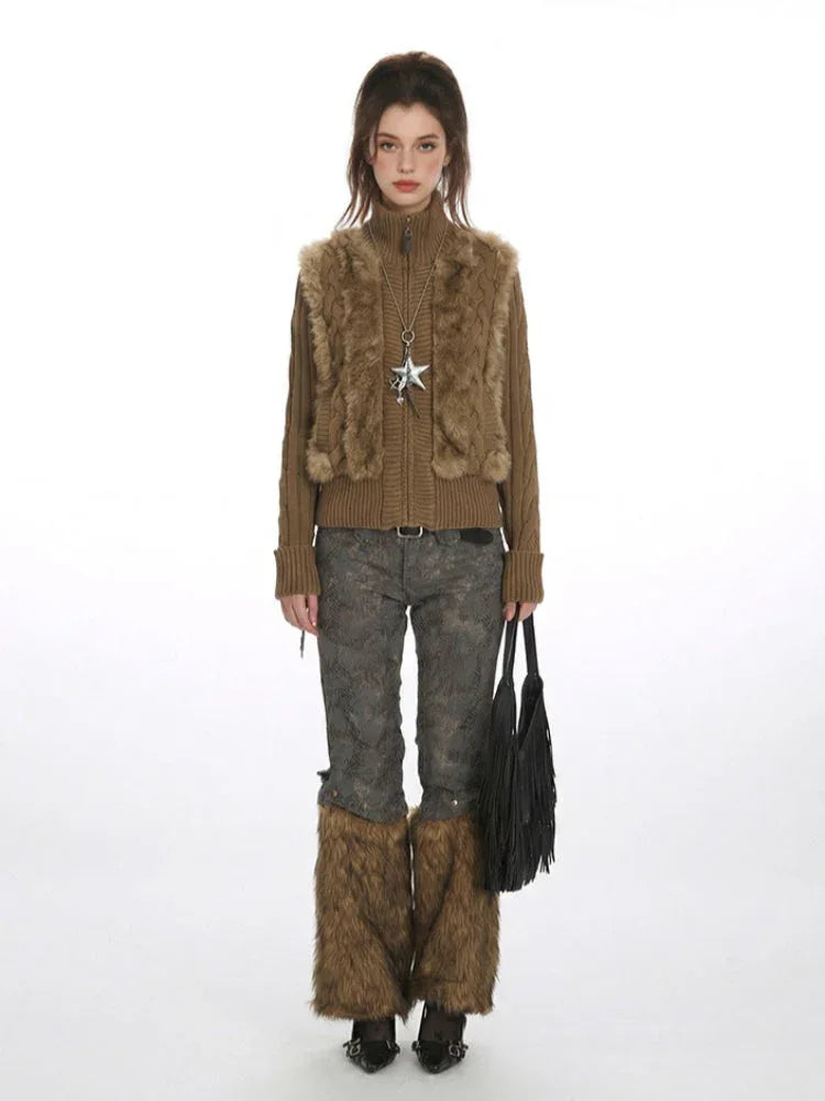 Woman wearing a brown faux fur vest over a brown turtleneck sweater, grey embroidered trousers, and brown faux fur leg warmers.