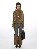 Woman wearing a brown faux fur vest over a brown turtleneck sweater, grey embroidered trousers, and brown faux fur leg warmers.
