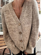 Model showcasing the front of a textured beige cardigan