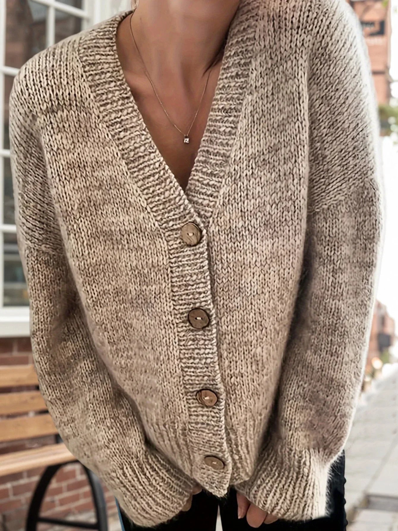 Model showcasing the front of a textured beige cardigan
