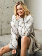 Woman wearing a white and grey faux fur coat with a shawl collar