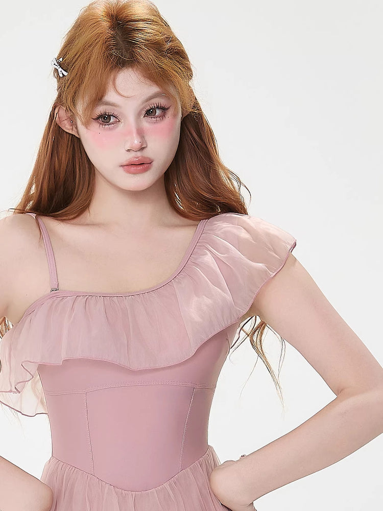 Model wearing a pink one-shoulder ruffled dress with a sheer skirt