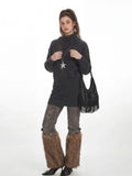 Model posing with a black fringe handbag while wearing a charcoal grey knit tunic sweater.