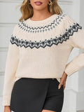 Woman wearing a cream-colored knit sweater with a black and grey Fair Isle pattern, paired with black pants.