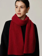 Woman wearing red ribbed knit scarf with black top