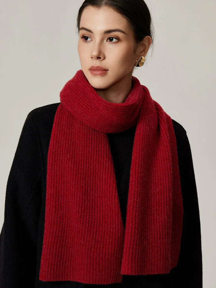 Woman wearing red ribbed knit scarf with black top
