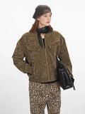 Close-up of a woman wearing a brown crushed velvet bomber jacket