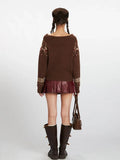 Back view of a woman in a brown Fair Isle knit sweater with a bear and bow pattern.