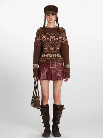 Woman wearing a brown Fair Isle knit sweater with a bear and bow pattern, paired with a red skirt and brown boots.