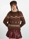 Close-up of a woman wearing a brown Fair Isle knit sweater with a bear and bow pattern, showcasing the neckline.