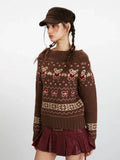 Side view of a woman wearing a brown Fair Isle knit sweater with a bear and bow pattern, styled off the shoulder.