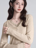 Back view of a woman in a grey ribbed knit cropped tank top with lace trim on the neckline.