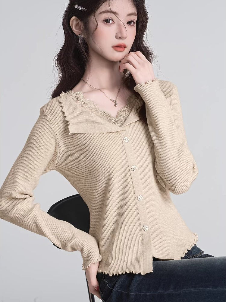 Woman wearing a grey ribbed knit cropped tank top with lace trim and a small bow detail on the square neckline.