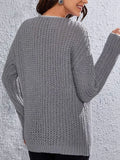 Back view of a woman in a grey textured knit sweater.