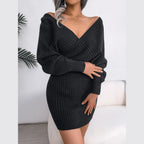 Woman wearing a charcoal grey knit wrap dress with long sleeves