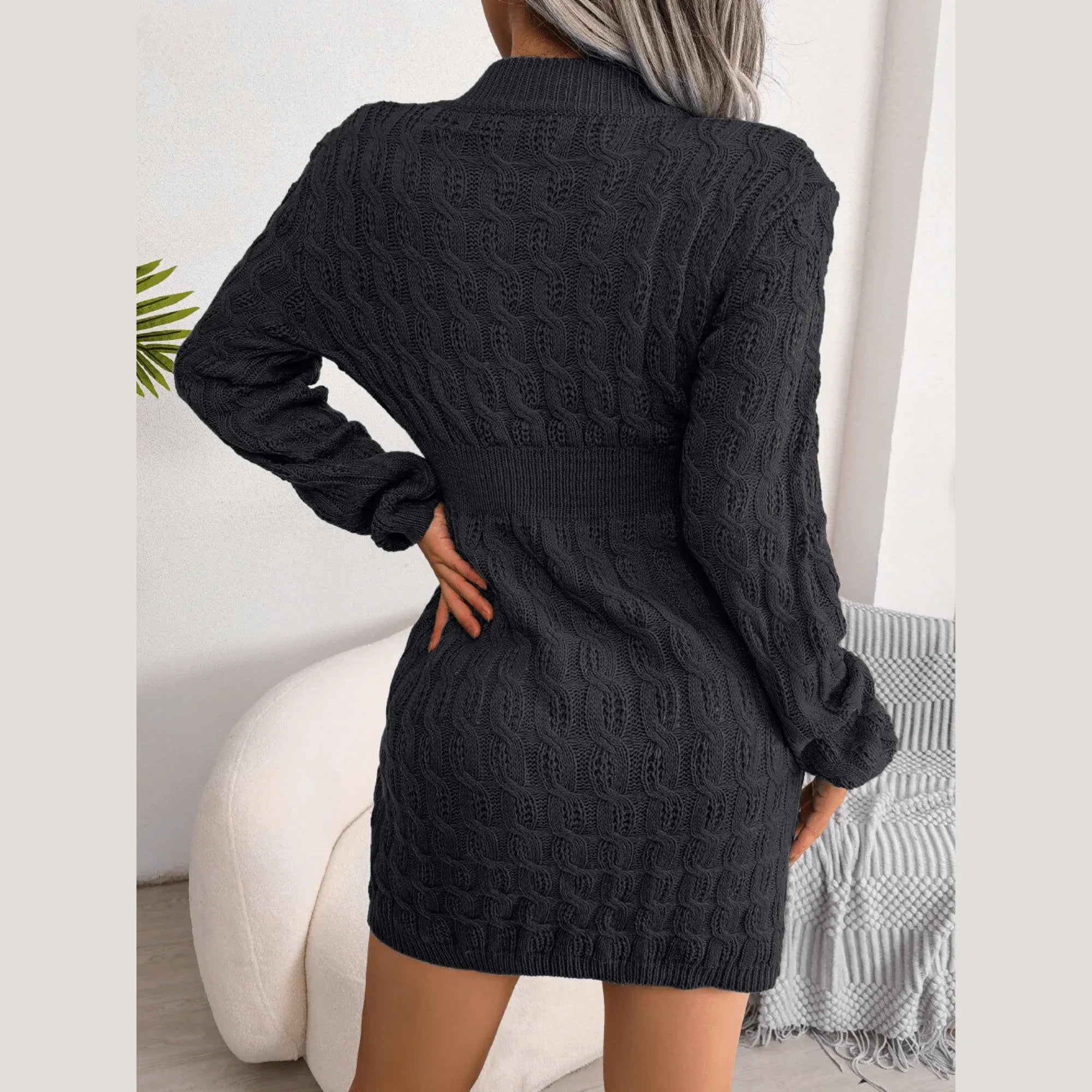Back view of a woman in a black bodycon knit dress with cable knit pattern