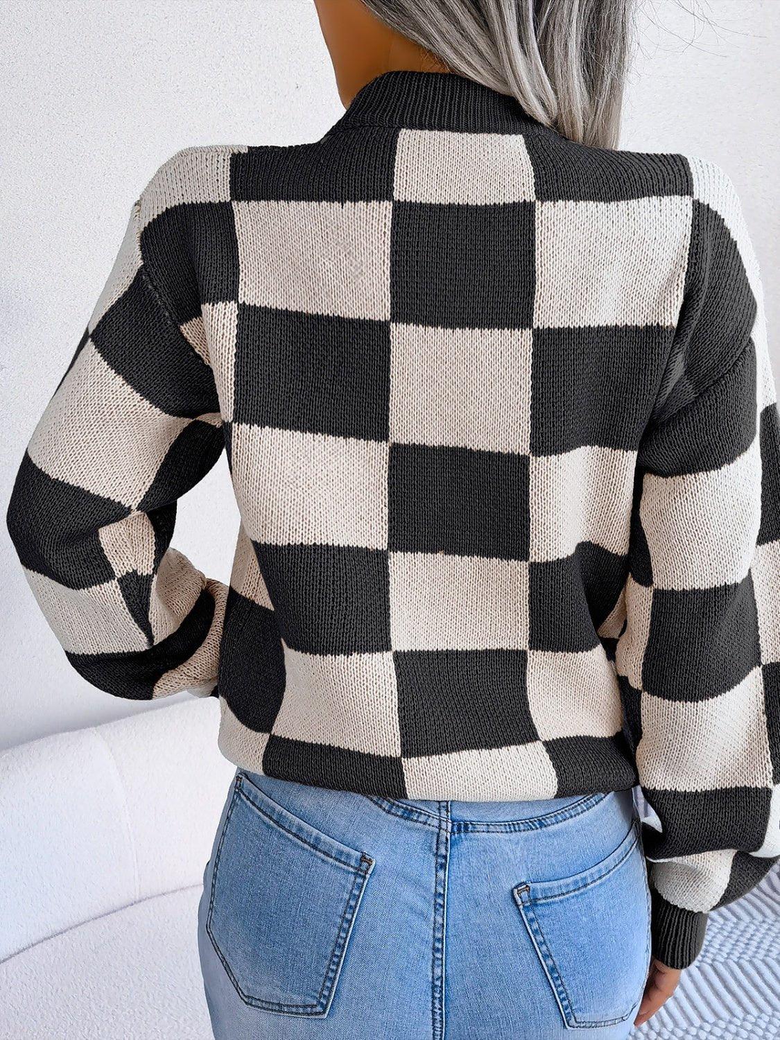 Back view of a woman wearing a black and cream checkerboard knit sweater.