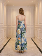 Back view of a woman in a maxi dress with a fruit and floral print.