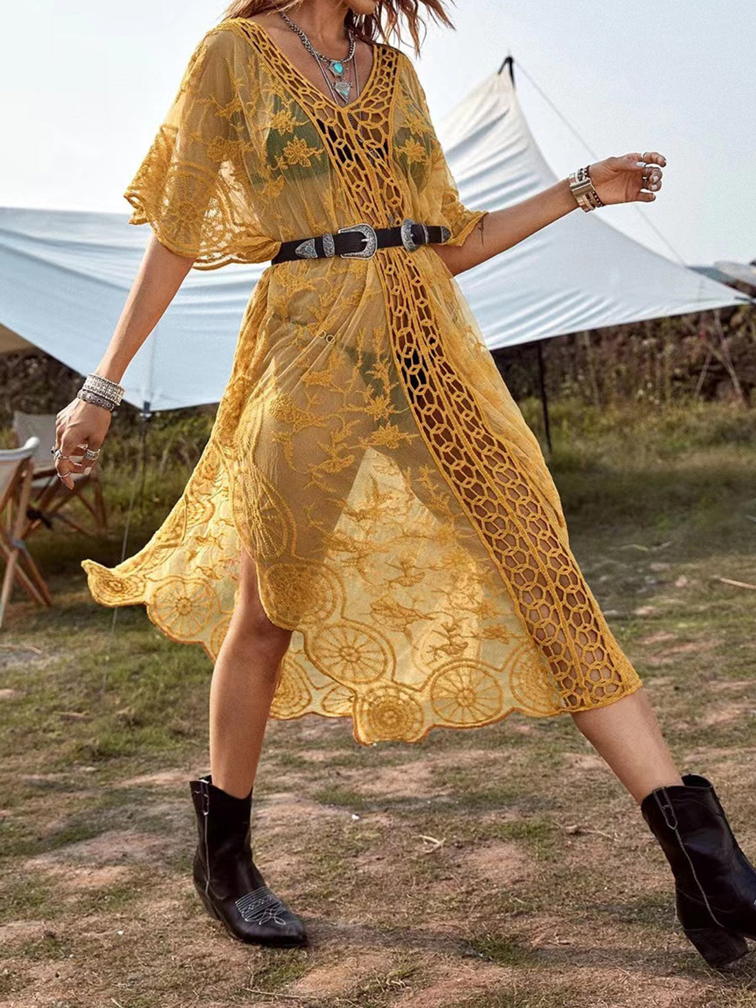 Woman wearing a white lace maxi beach cover up on the beach