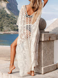 Back view of a woman in a white lace maxi beach cover up