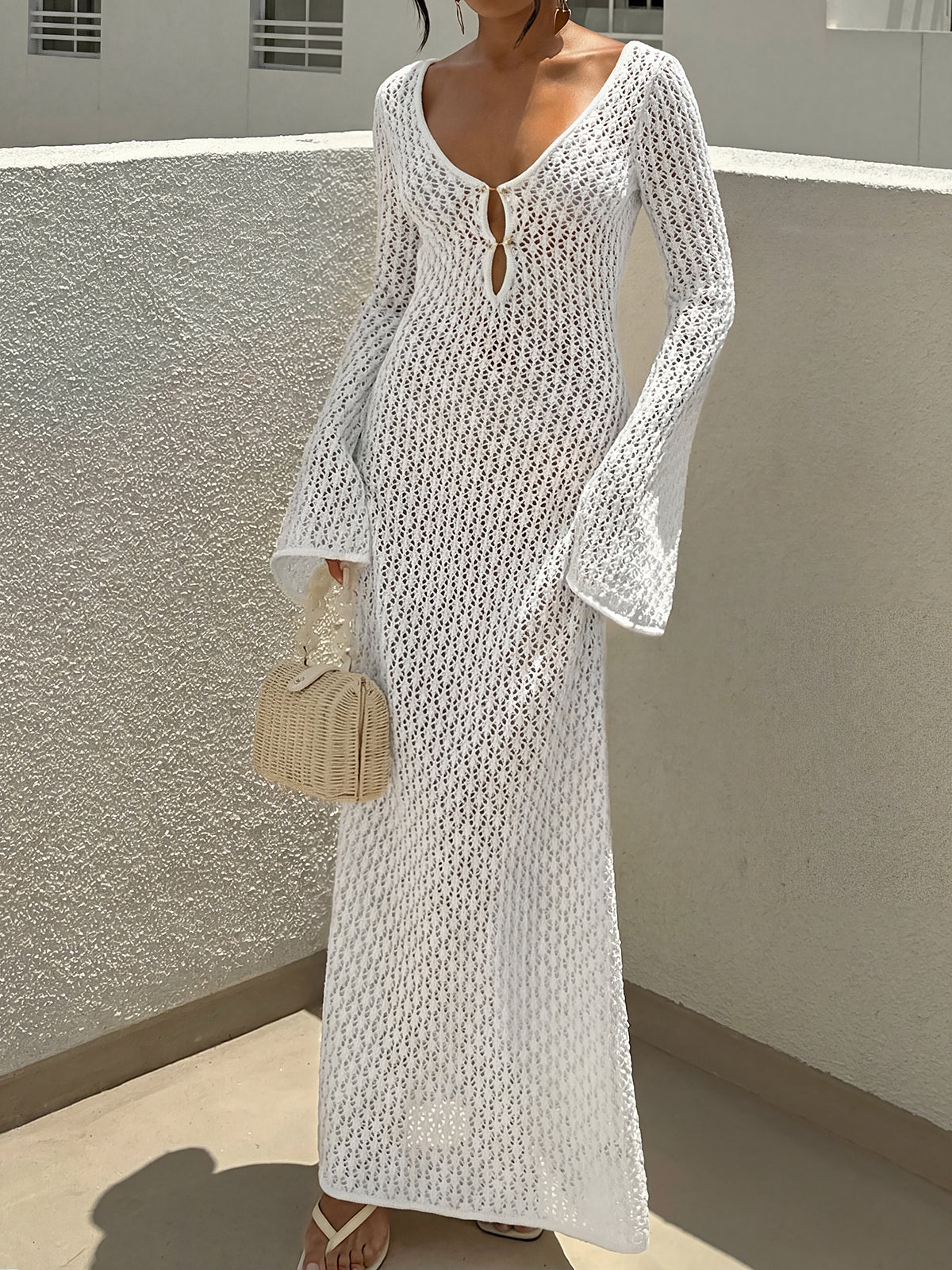 woman wearing a white long sleeve crochet maxi dress