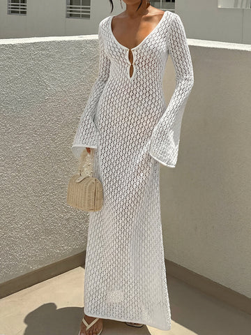 woman wearing a white long sleeve crochet maxi dress