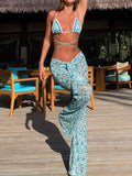 Woman wearing a blue and white patterned bikini top with matching wide-leg palazzo pants with side slits