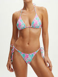 Woman wearing a pink and teal shell print triangle bikini top with adjustable halter ties