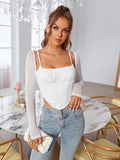 Front view of a woman in a white ruched bust corset top with sheer long sleeves