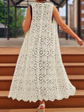 Woman from the back wearing a white open-knit maxi vest with a flowing hem.
