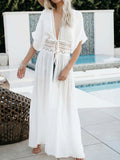 Woman wearing a white maxi beach cover-up with lace waist detail
