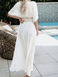 Back view of a woman wearing a white maxi beach cover-up
