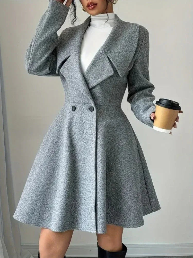Woman in a grey wool blend tweed coat holding a coffee cup.