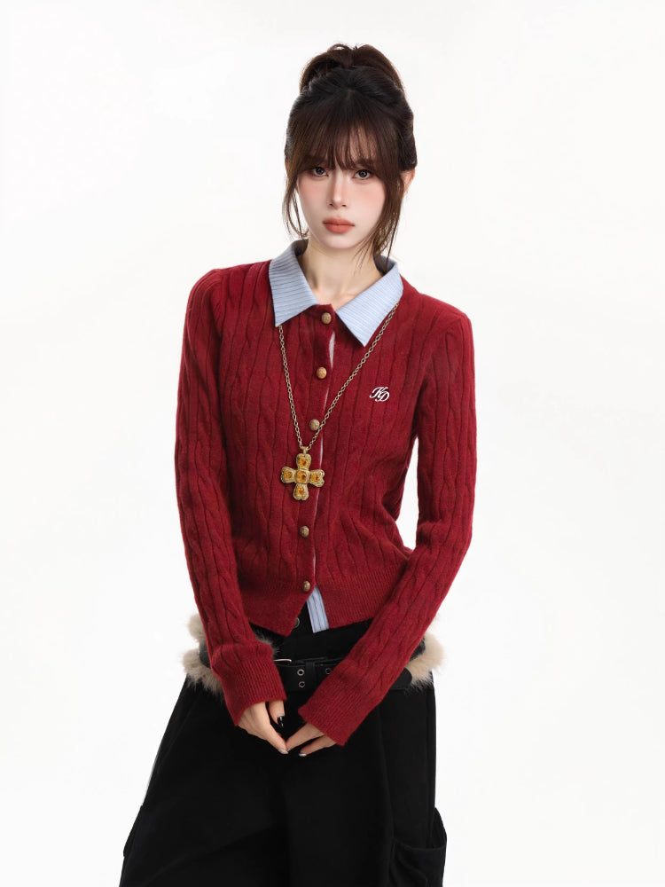 Woman wearing a red cable knit cardigan with a blue collared shirt underneath and a gold cross necklace.