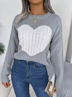 Front view of a grey crew neck sweater with a white cable knit heart design.