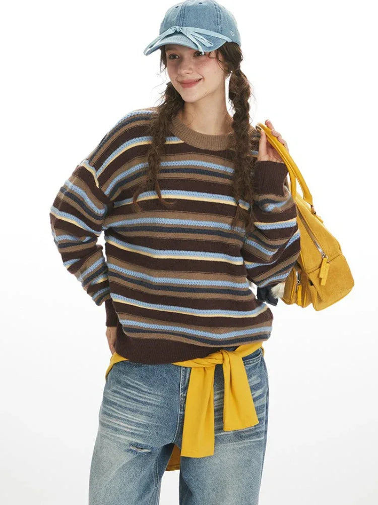 Close-up of a woman wearing a striped knit sweater.