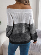 Back view of a woman in an off-the-shoulder color block knit sweater.