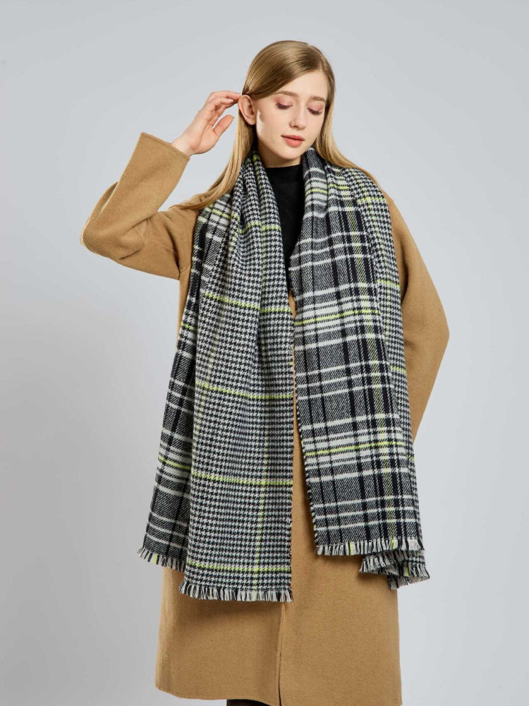 Woman posing with a plaid and houndstooth pattern scarf.
