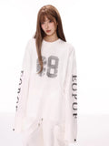 Close-up of the graphic print on the white long-sleeve t-shirt.